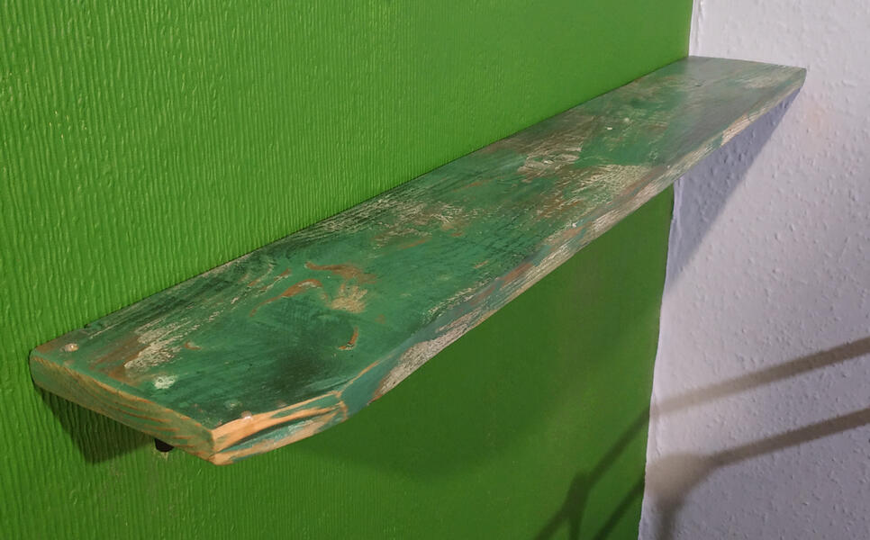 Mounted shelf with distressed wood and green paint